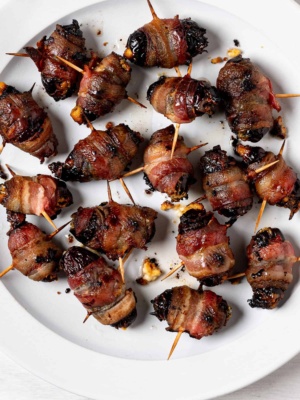 Baked Bacon wrapped dates on plate