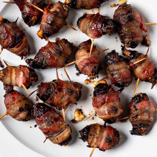 Baked Bacon wrapped dates on plate