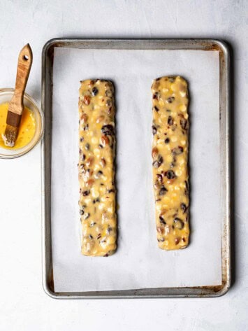 biscotti logs formed on baking sheet and getting egg wash