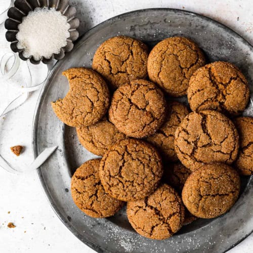 Baked Ginger-miso cookies on platter with bowl of can sugar for dusting