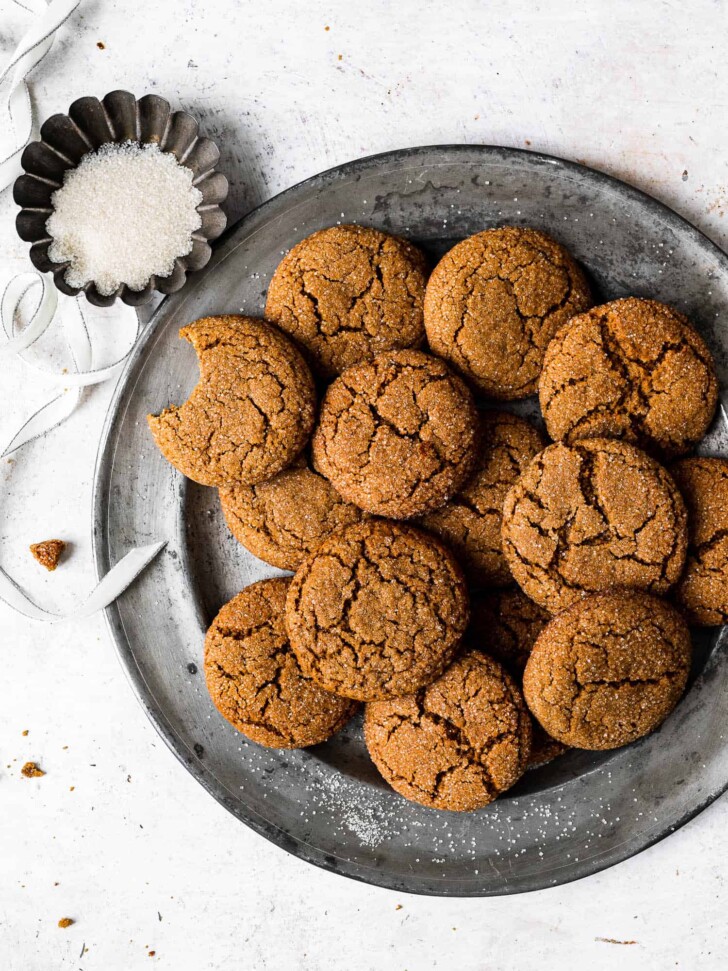 Baked Ginger-miso cookies on platter with bowl of can sugar for dusting