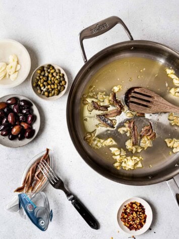 anchovies and garlic frying in saucepan