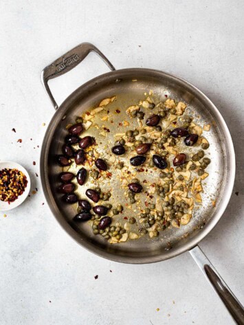 olives and capers added to skillet 