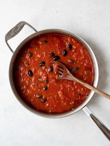 tomatoes added to mixture in saucepan