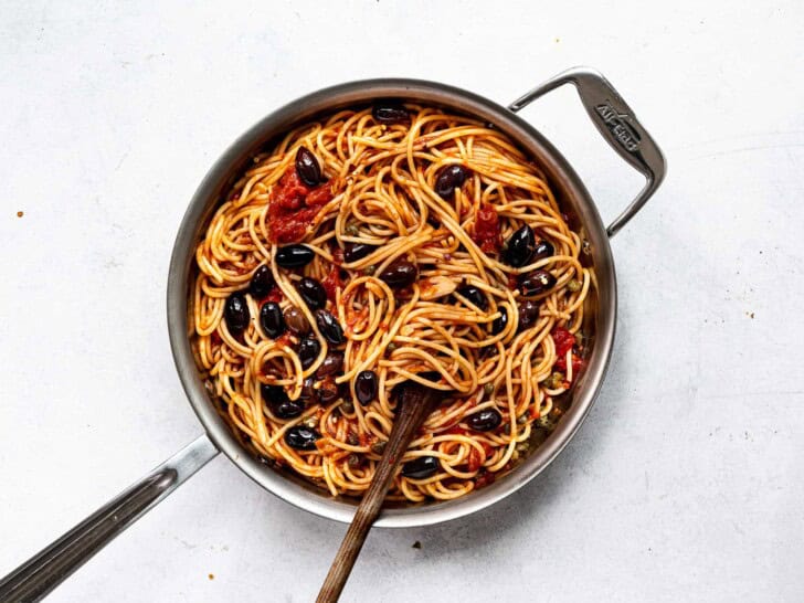 spaghetti tossed with sauce in saucepan