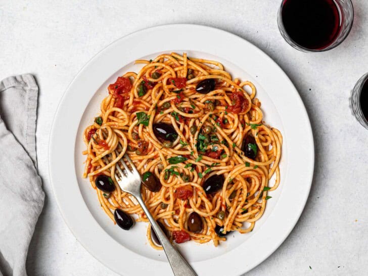 close up of pasta puttanesca served on plate