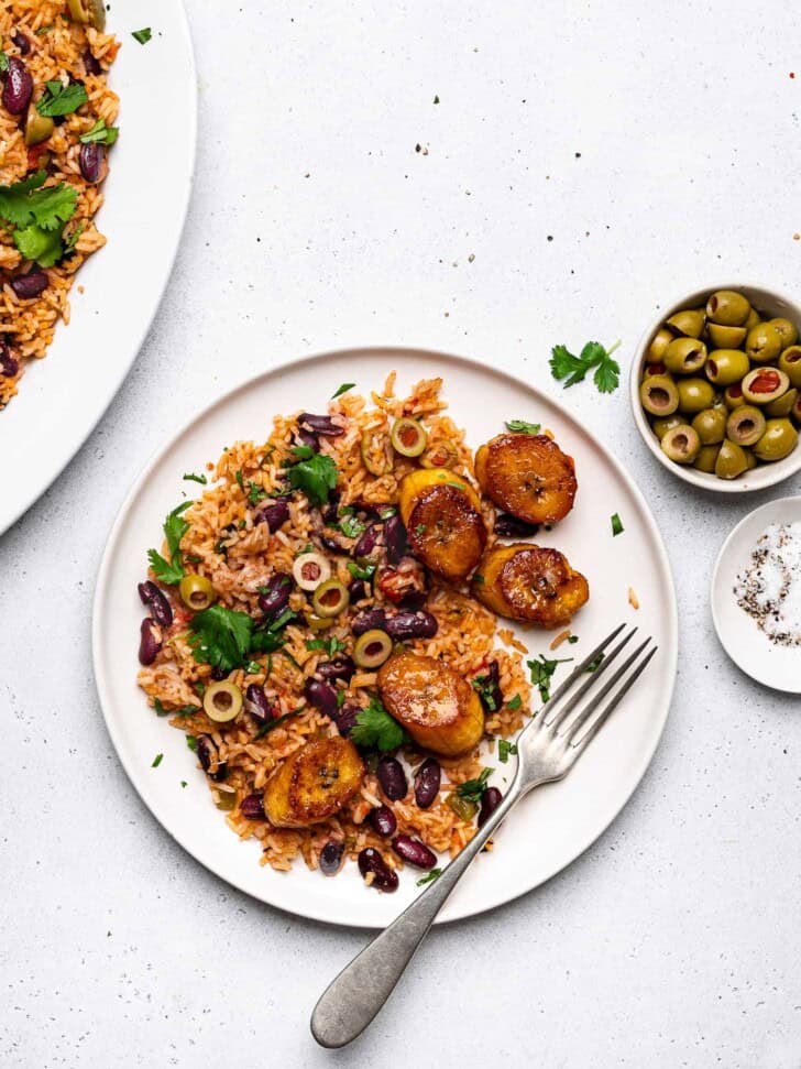 one-pot rice and beans served on plate with plantains