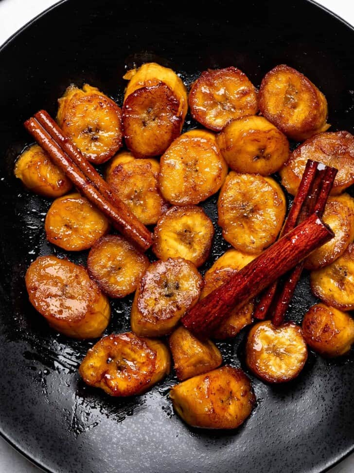 close-up of Plátanos al Caldero (sweet caramelized plantains) served on plate