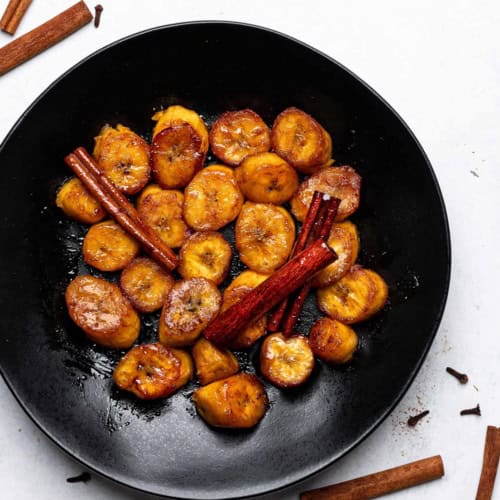 Plátanos al Caldero (sweet caramelized plantains) served on plate
