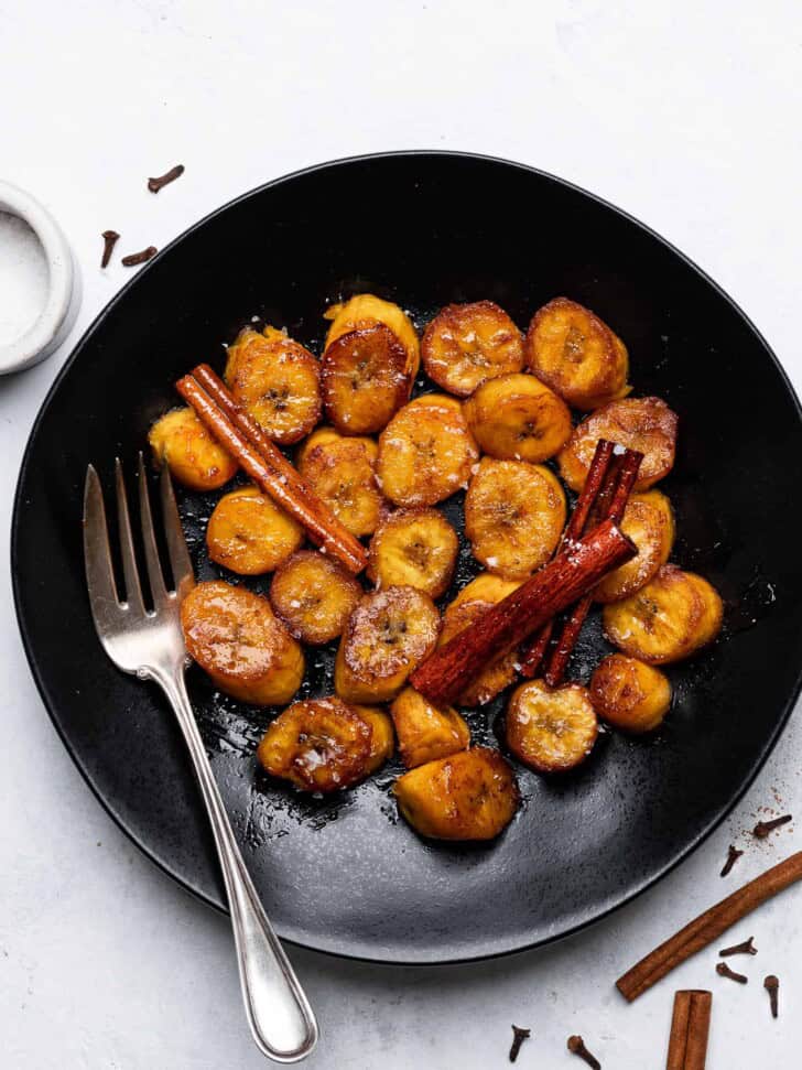 Plátanos al Caldero (sweet caramelized plantains) served on plate with flaky salt