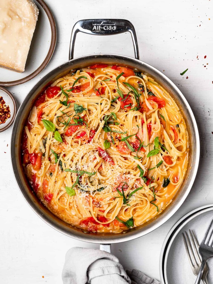 adding Reggiano to cooked pasta