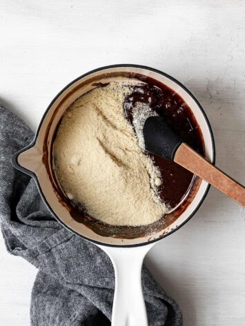 adding almond flour mixture to chocolate mixture