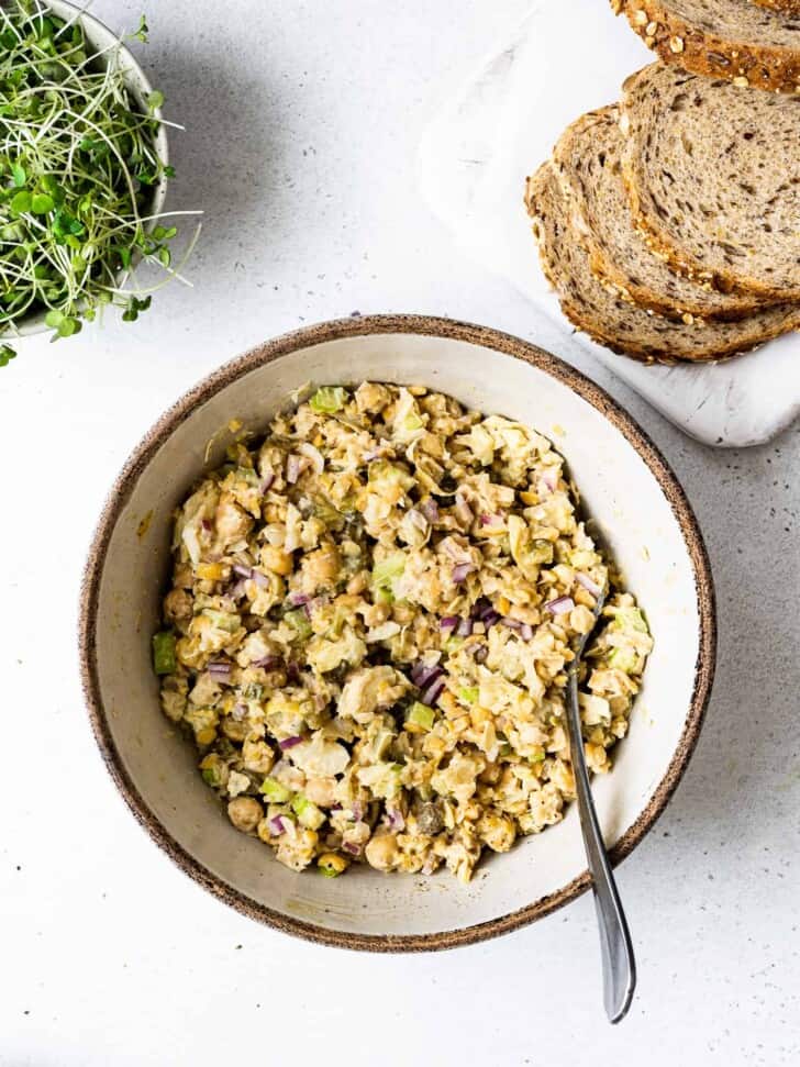 mixture in bowl shown with bread and micro greens