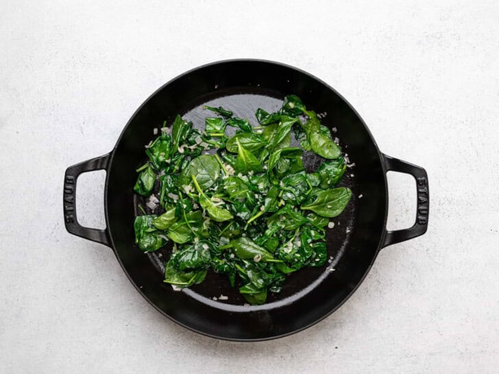 cooking spinach in skillet