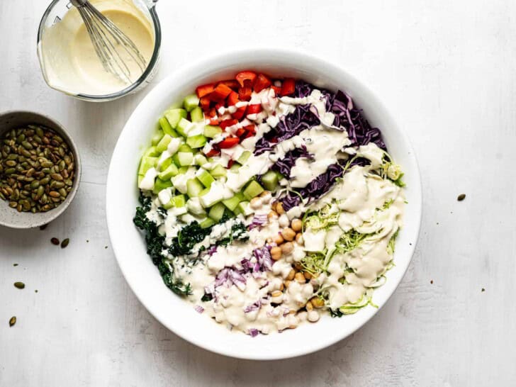 chopped kale salad with tahini dressing poured over top