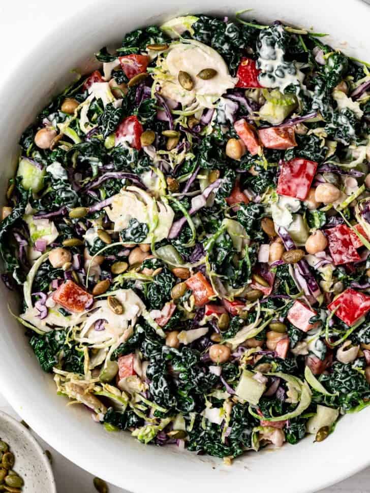 Close up of Chopped Kale Salad with tahini dressing in bowl 