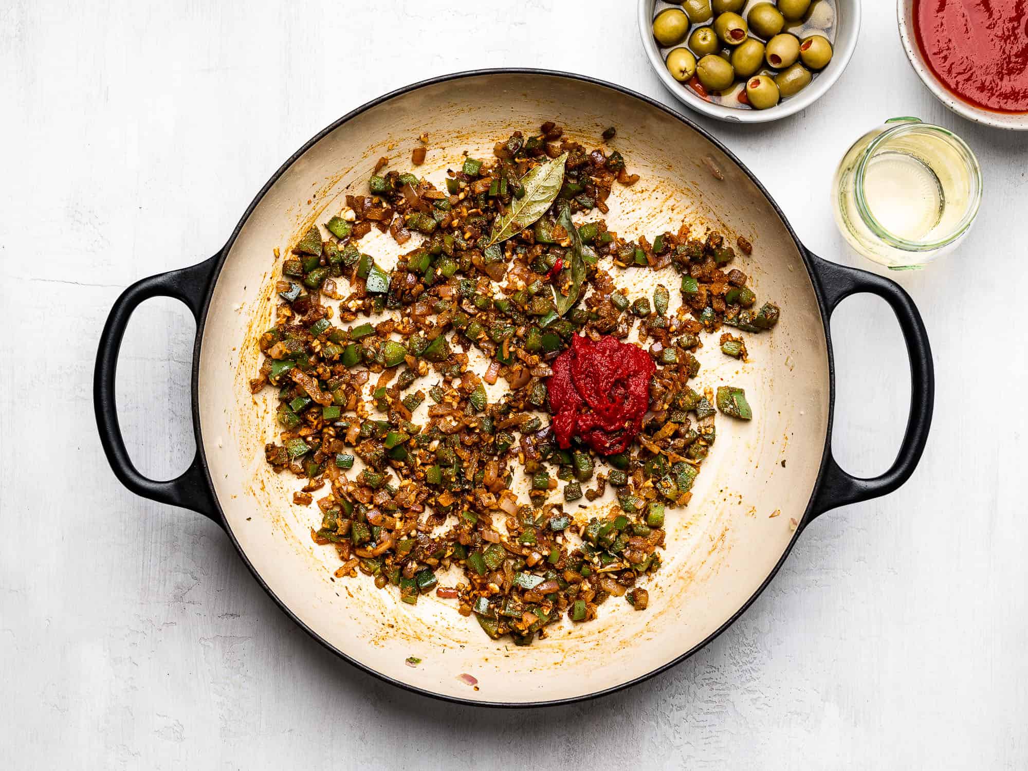 adding tomato paste to onion mixture