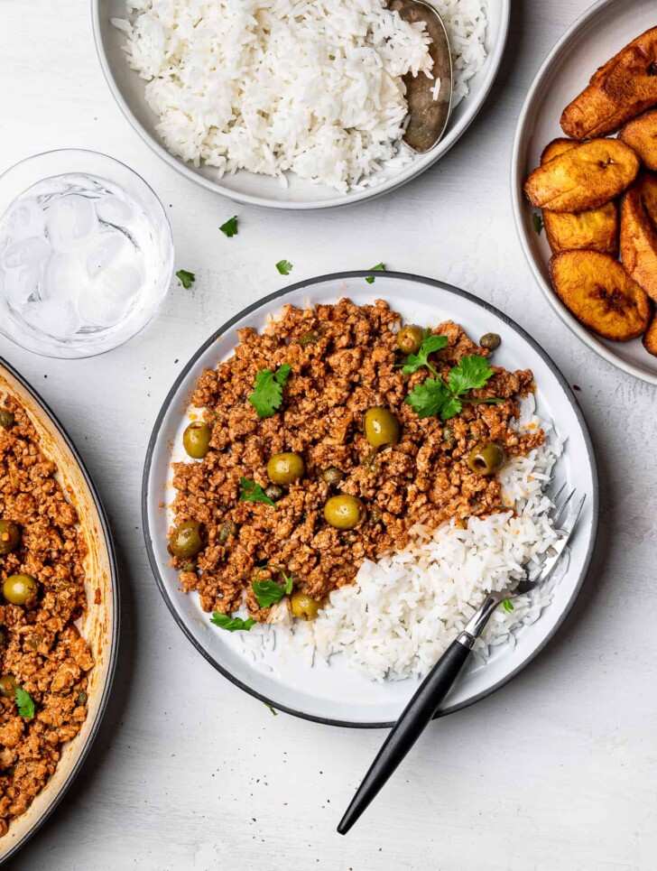 turkey picadillo served on plate with plantains and rice