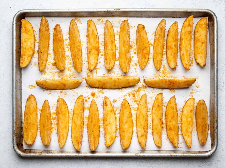 pre-baked potatoes wedges on sheet pan 