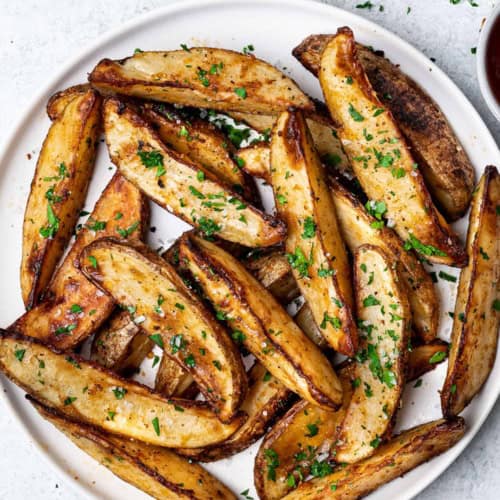 Baked Parmesan Potato Wedges served on plate