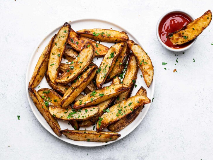 Baked Parmesan Potato Wedges served on plate with ketchup for dipping