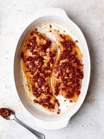 Raw fish in baking dish with chipotle sauce