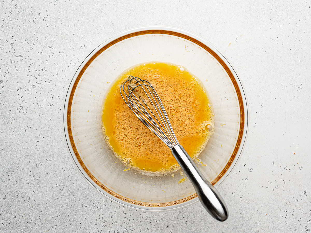 Eggs whisked with sugar mixture.