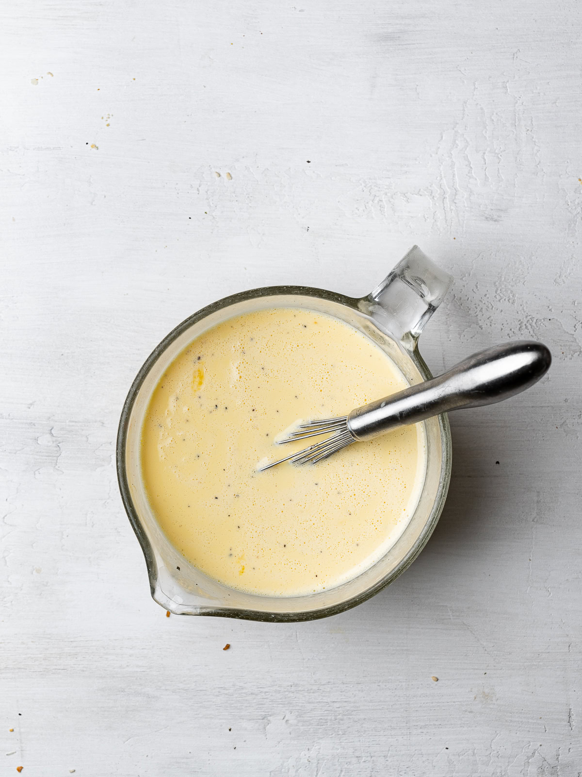 egg mixture in measuring cup for drenching bagels