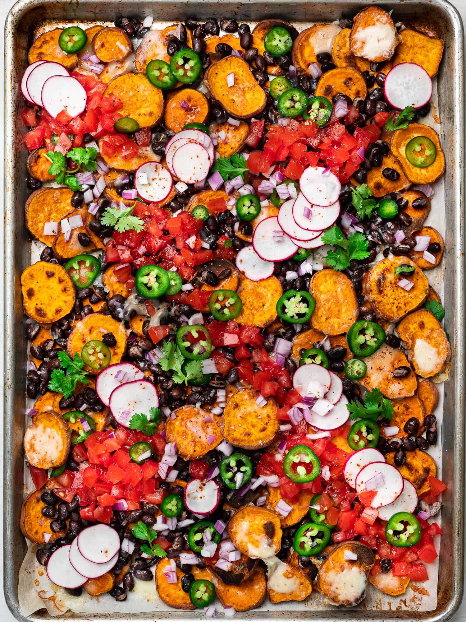 sweet potato nachos on sheet pan with toppings