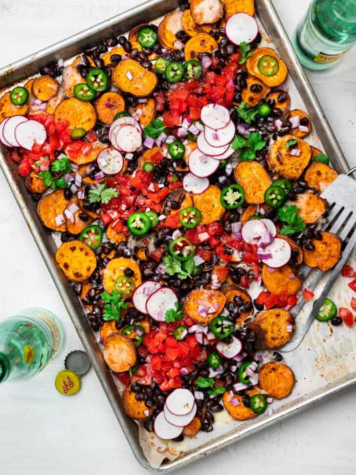 Sweet Potato Nachos with toppings on sheet pan