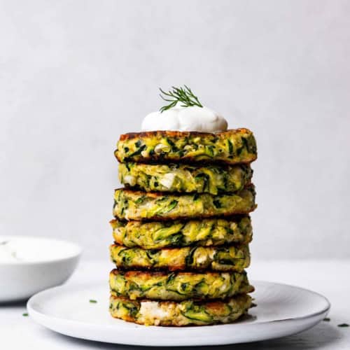 zucchini fritters piled on a plate