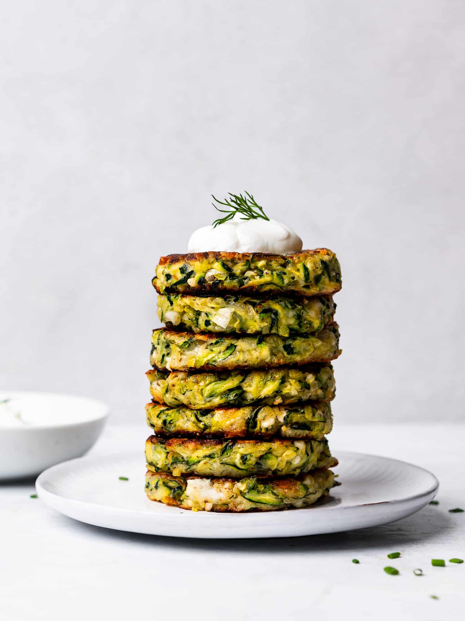 zucchini fritters piled on a plate
