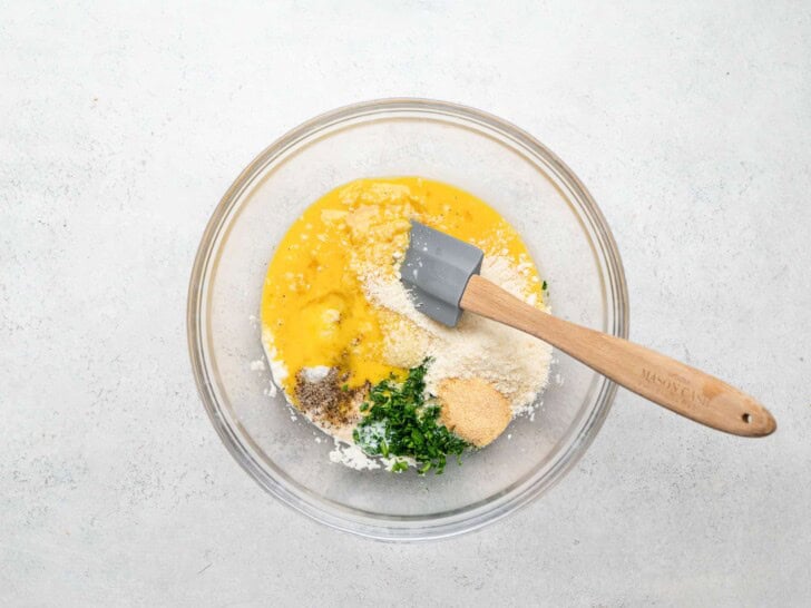 adding eggs parsley and garlic to soaked bread crumbs