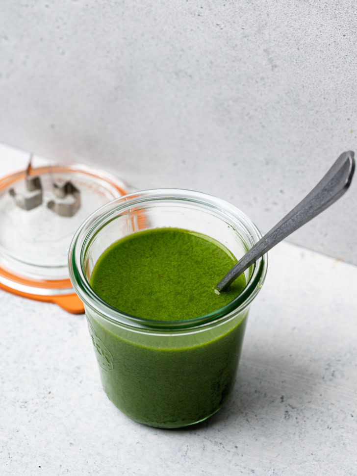 basil vinaigrette in jar with spoon