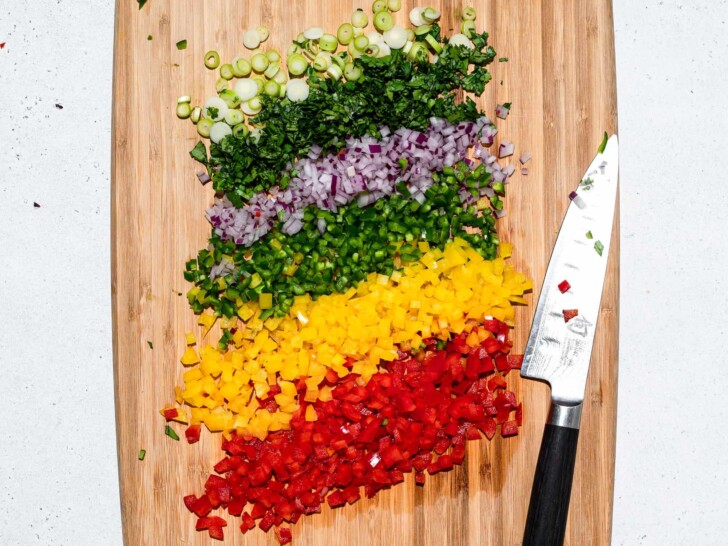 chopped veggies lined up on a cutting board 