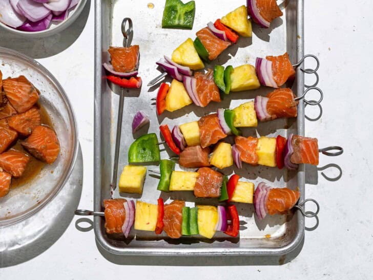 threading the fish, fruit, and veggies onto skewers