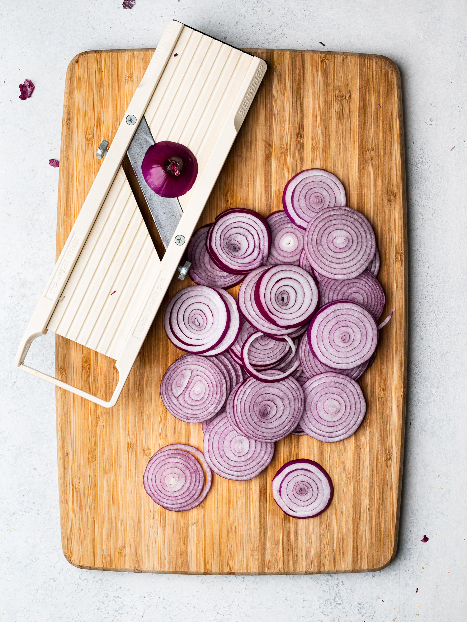 slicing red onions with mandolin