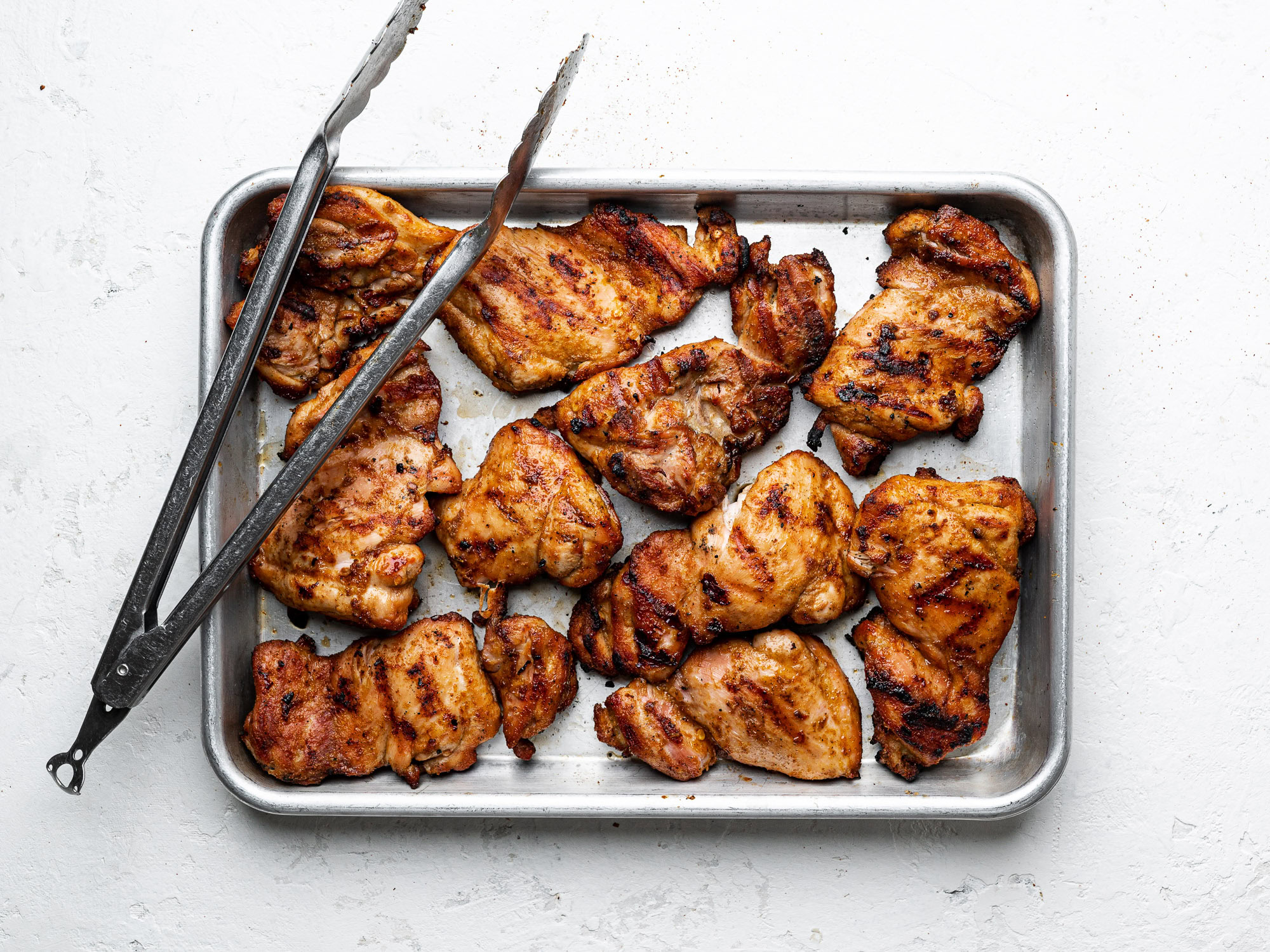 grilled chicken thighs on a sheet pan