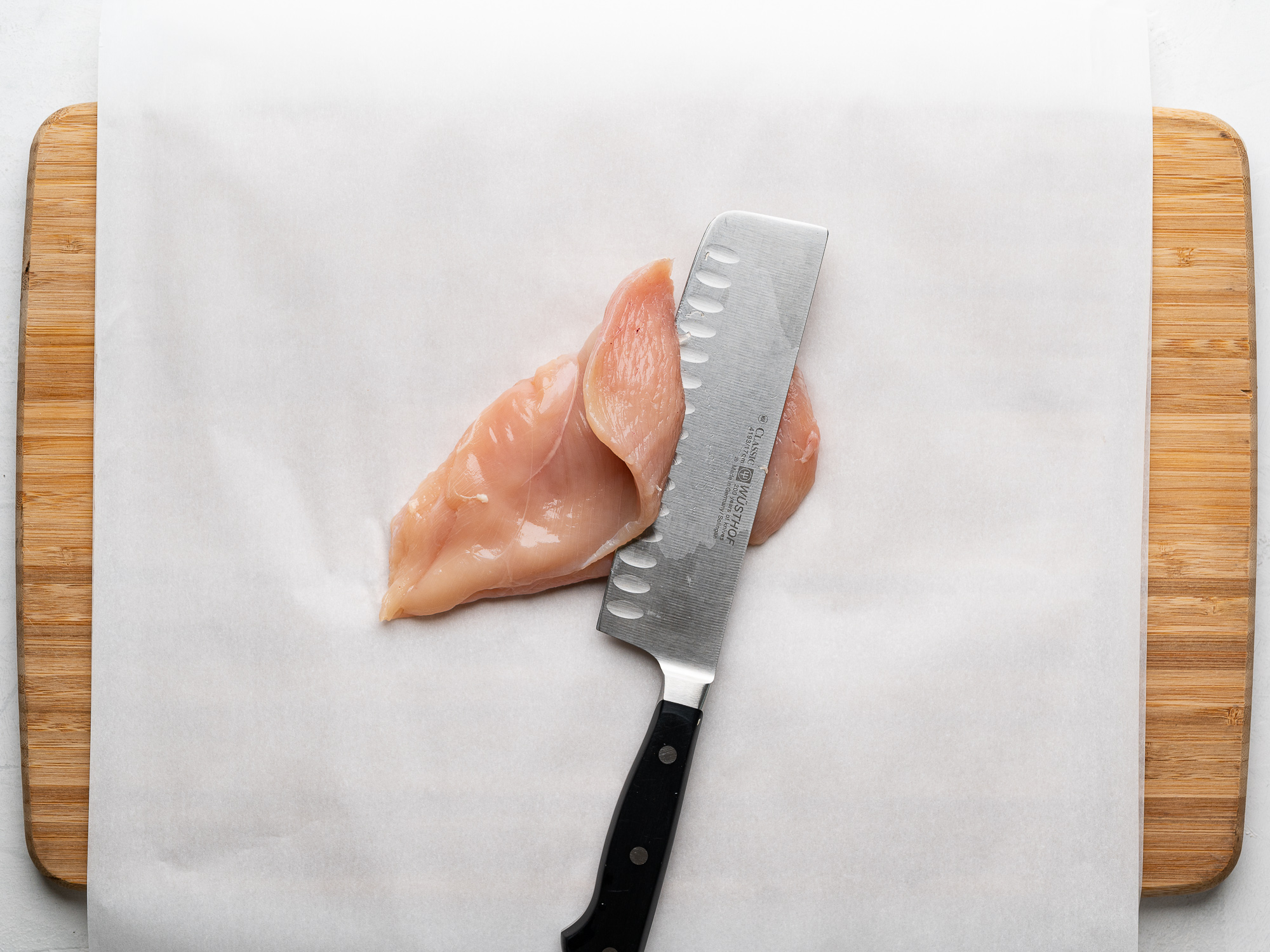 slicing chicken breast to make cutlets