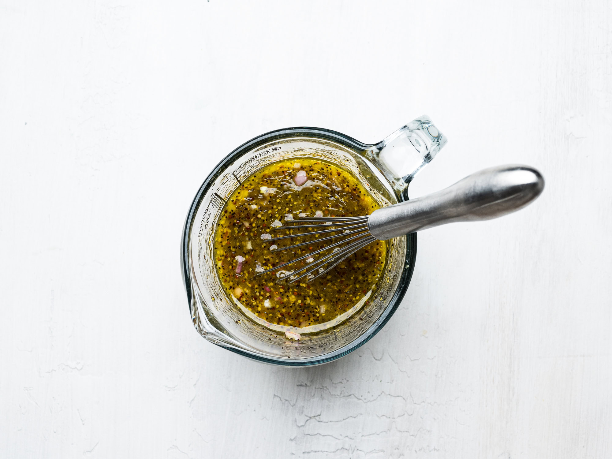 poppyseed dressing in glass measuring cup