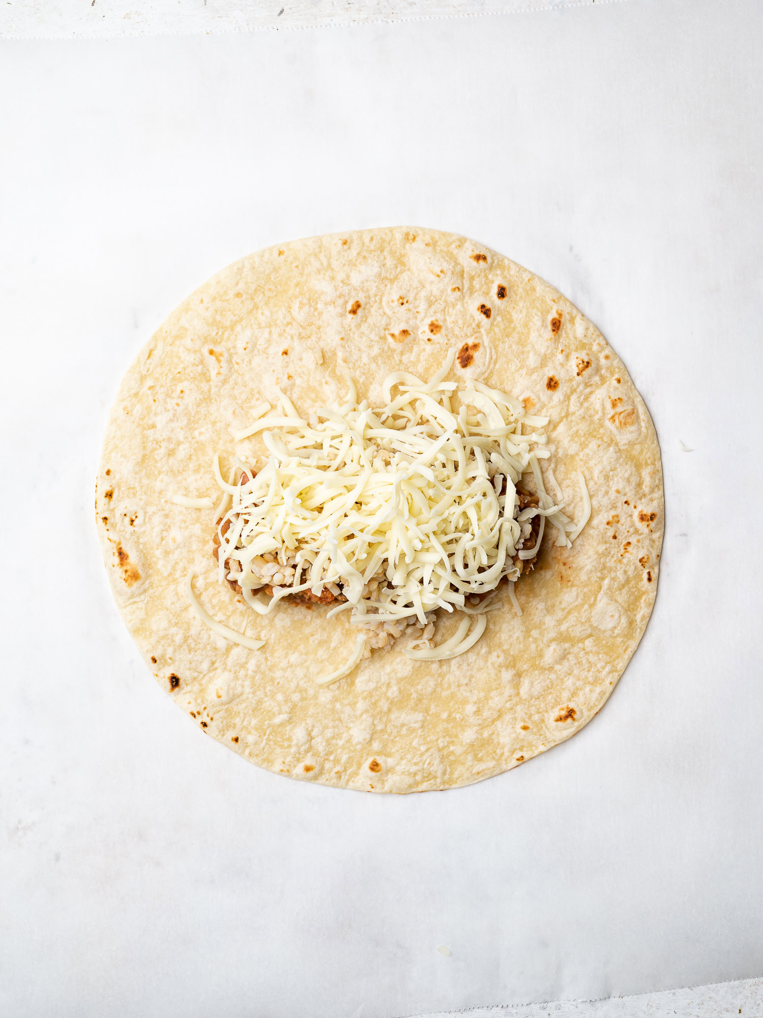 topping rice and beans with grated cheese