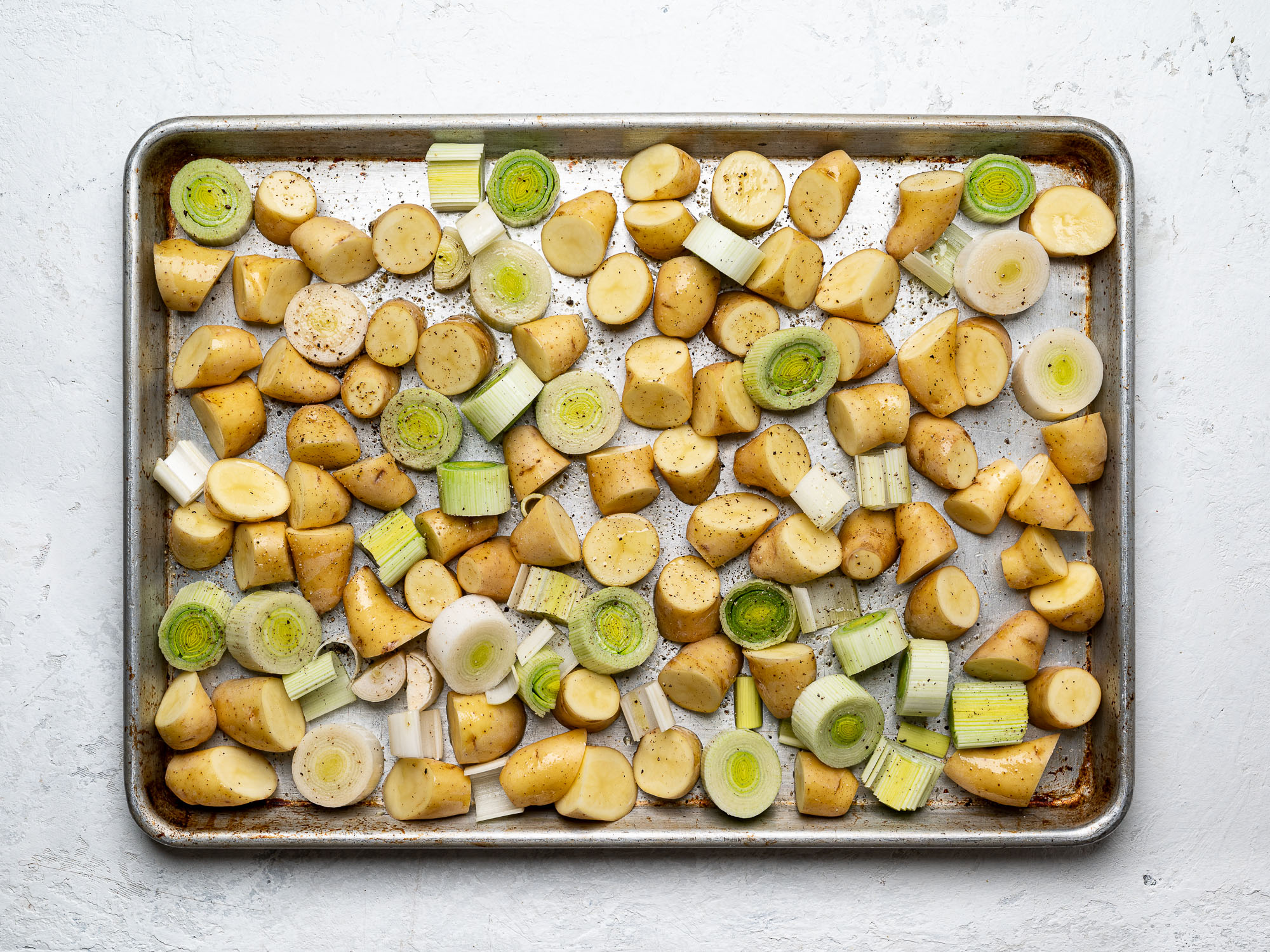 potatoes and leeks on sheet pan
