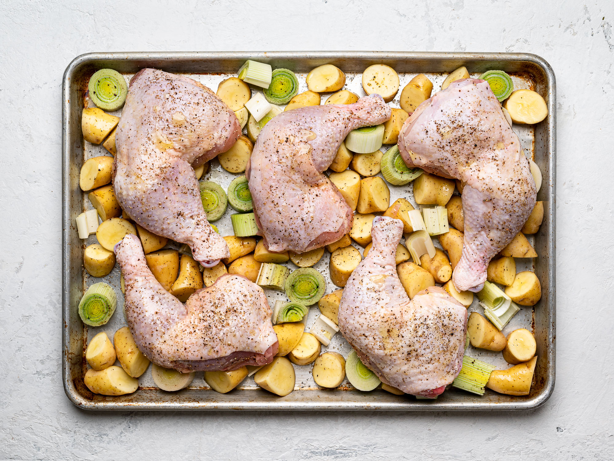 potatoes and leeks on sheet pan