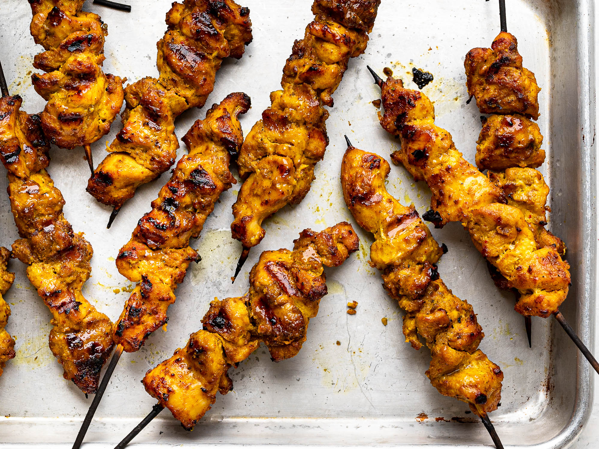 grilled chicken satay on baling sheet
