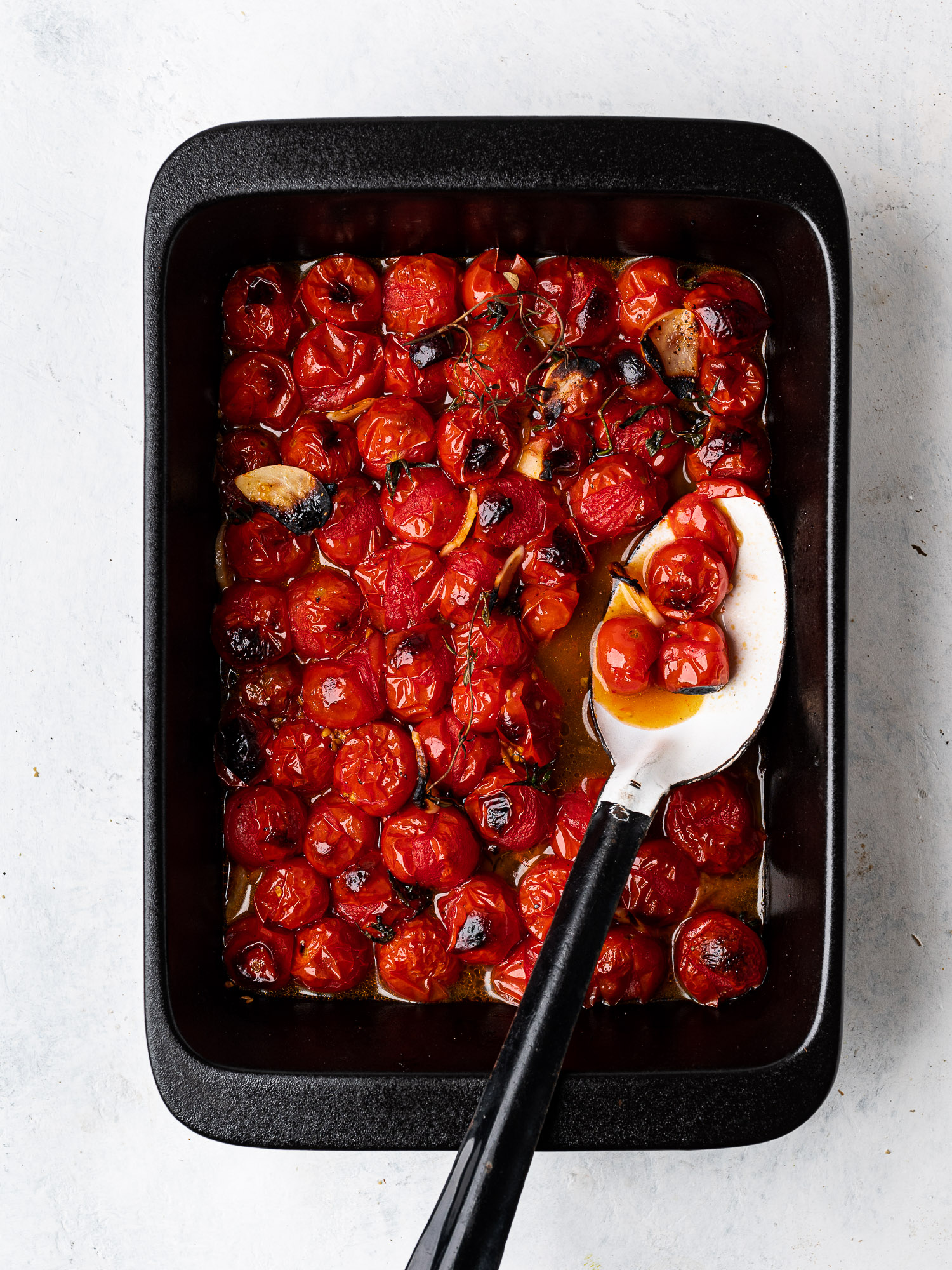blistered cherry tomatoes in baking dish