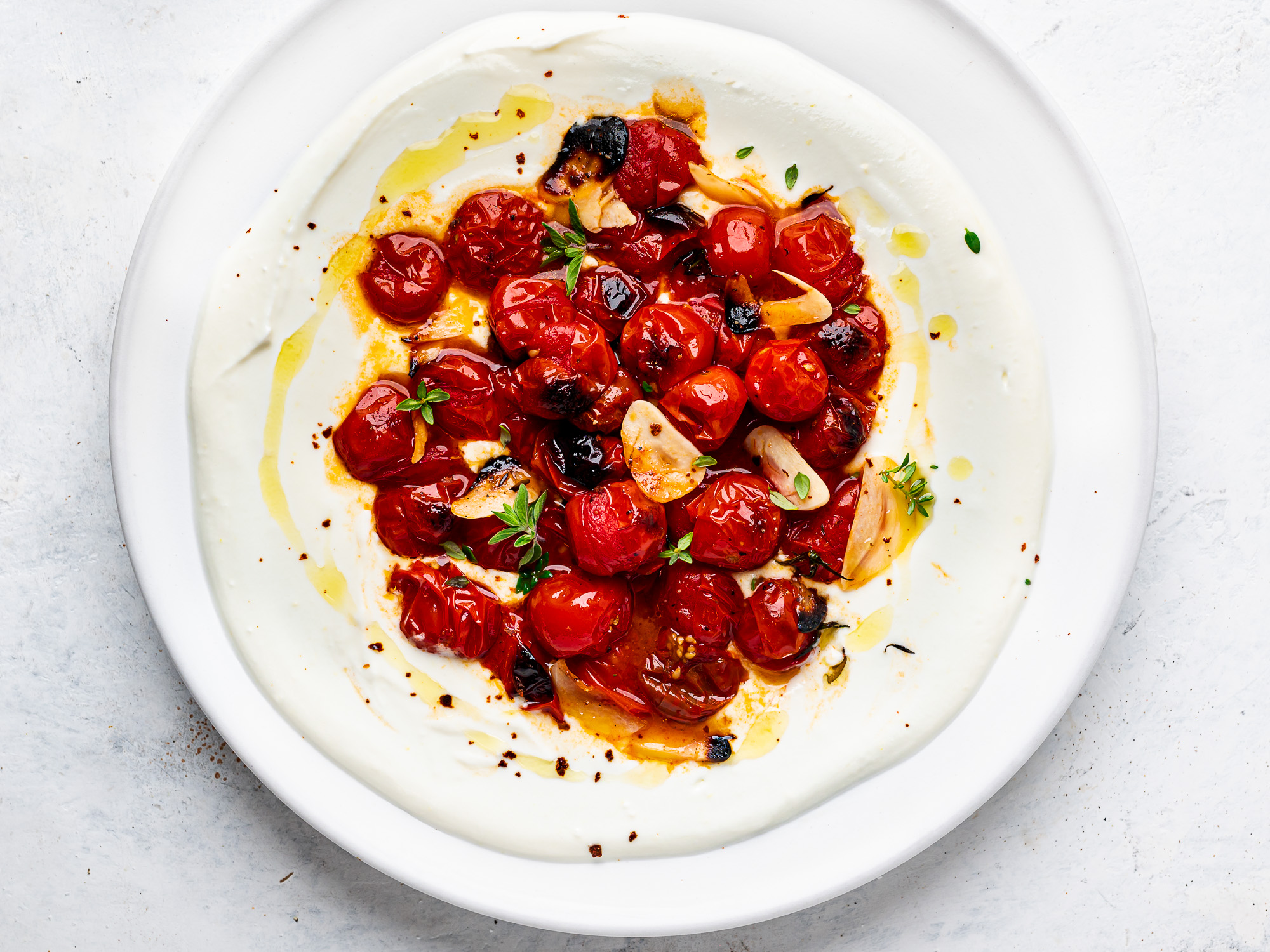 close-up of feta dip with hot tomatoes on top