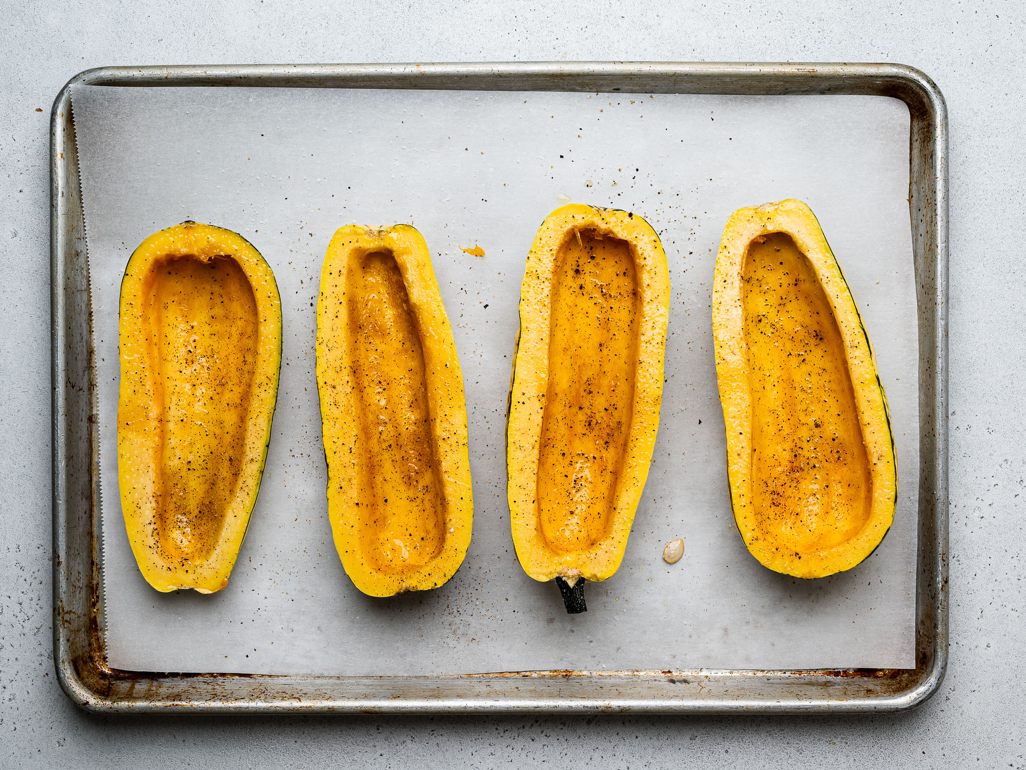 oiling and seasoning scooped-out squash