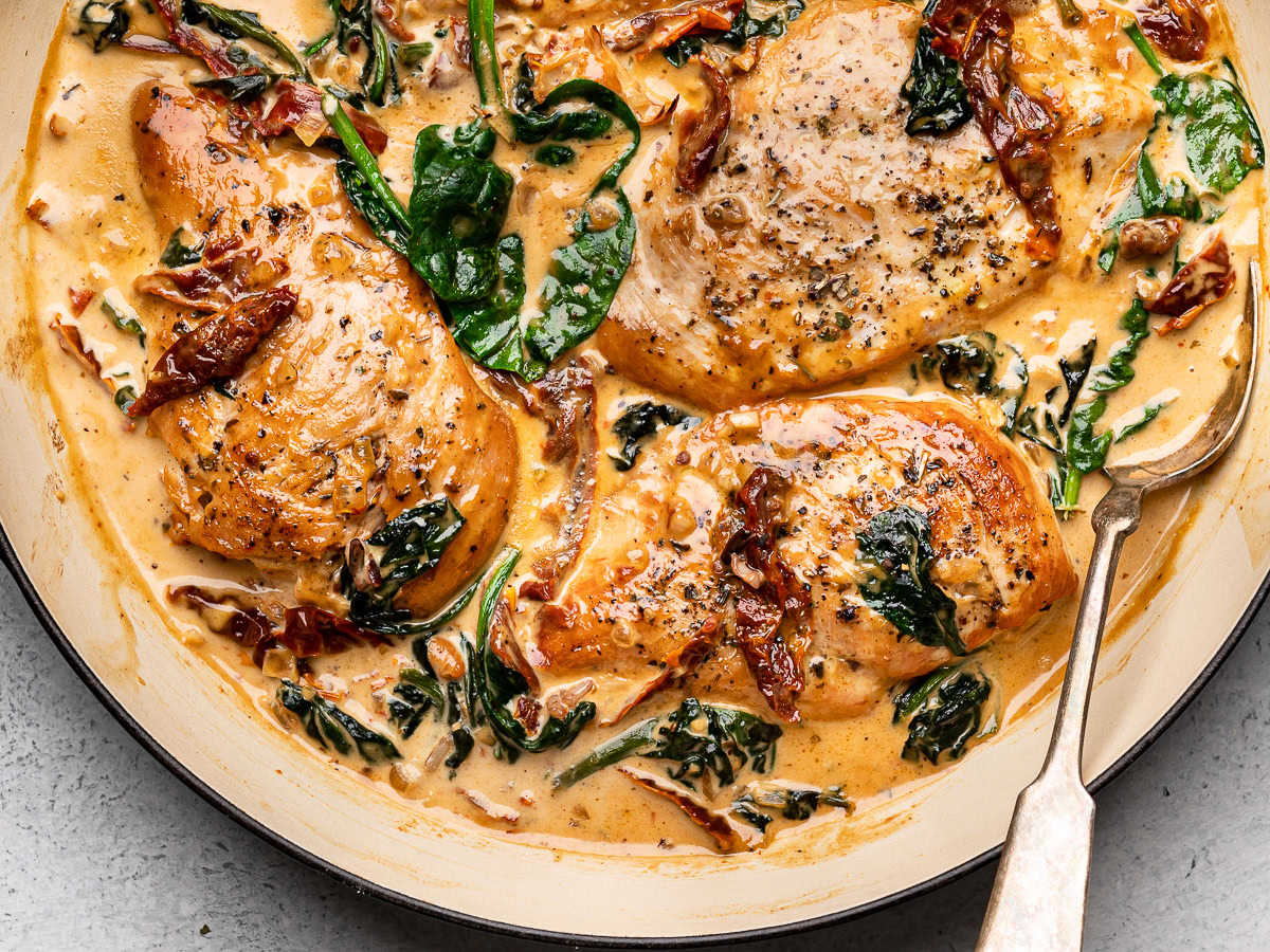 Cooked creamy Tuscan chicken in skillet