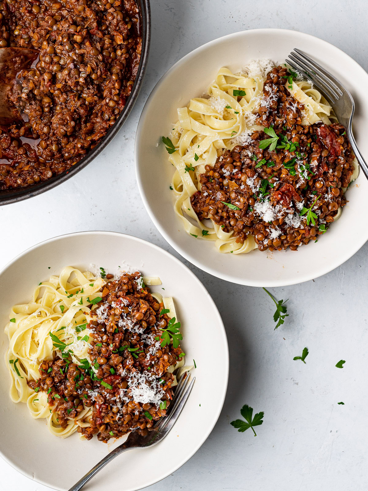 lentil bolognese served over pasta in bowls