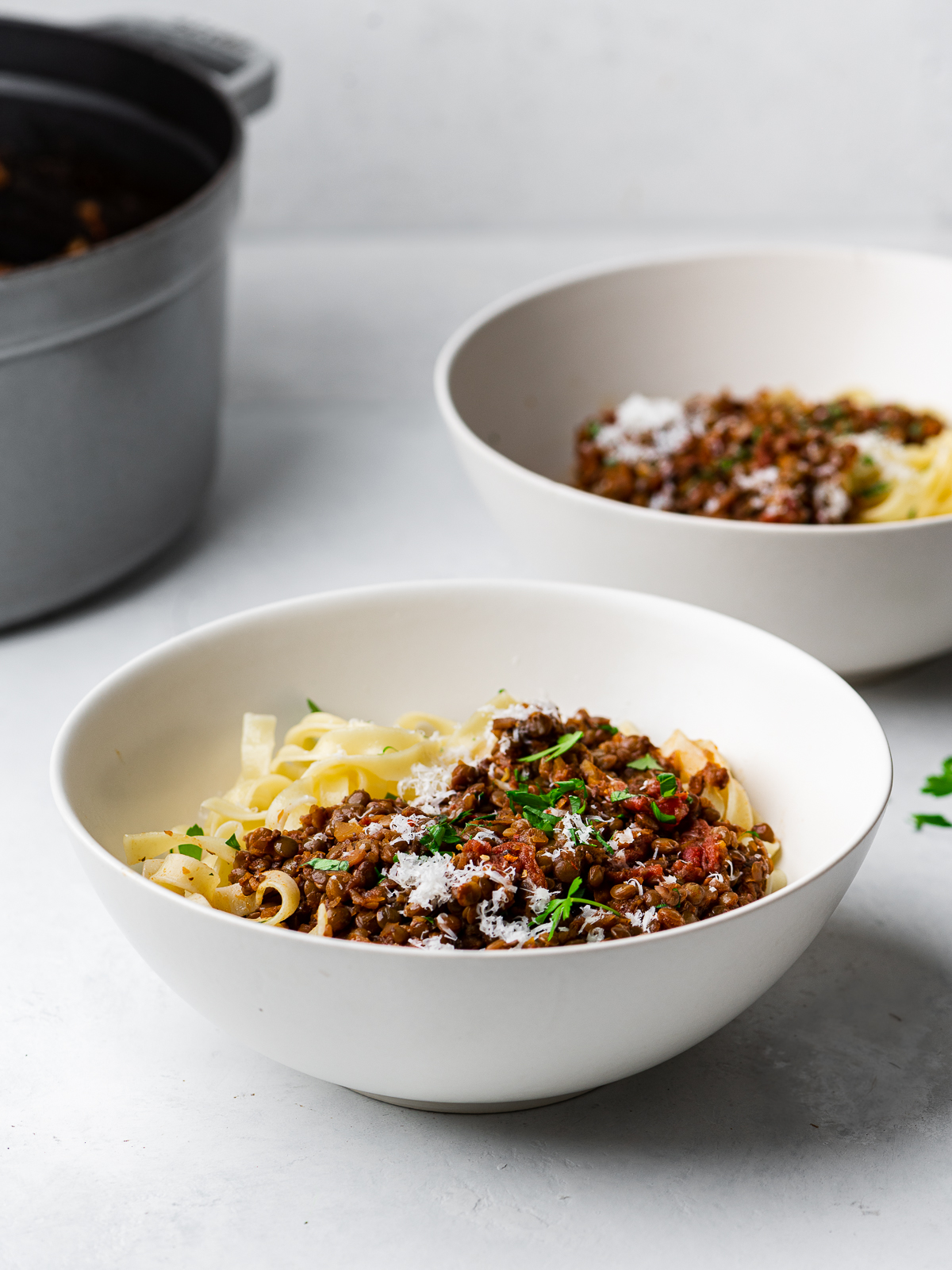 side-view of lentil bolognese served over pasta in bowls
